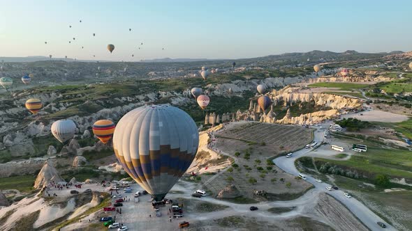 4K Aerial view of Goreme. Colorful hot air balloons fly over the valleys.