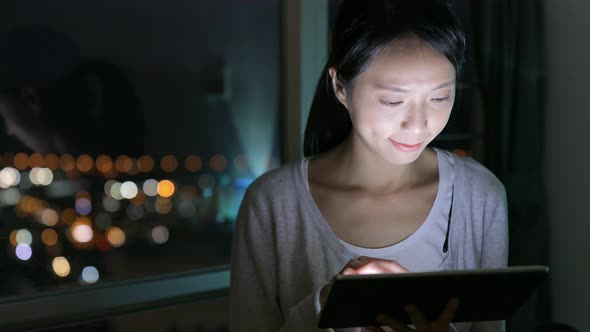 Woman browsing on digital tablet at home