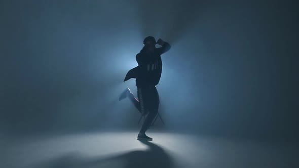 Young Man Dancer Dancing Funky Hip Hop on Isolated Studio Neon Blue Background, Slow Motion