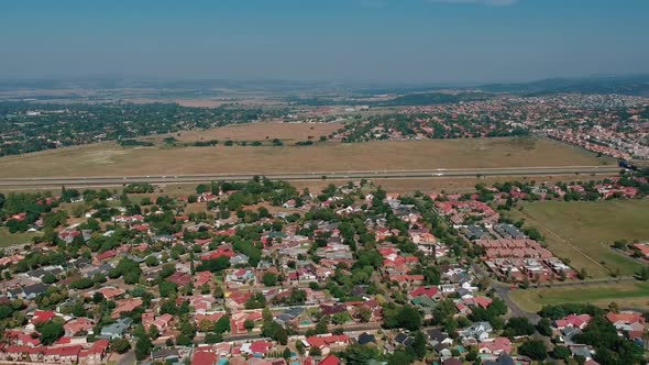 Arial pan shot of neighborhood and highway