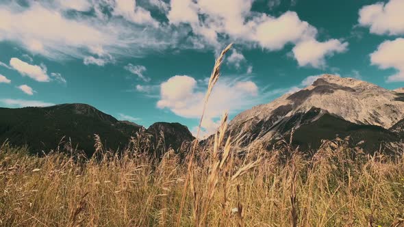 Fast clouds movement on sky in scenic mountains valley view. Landscape panorama with weather.