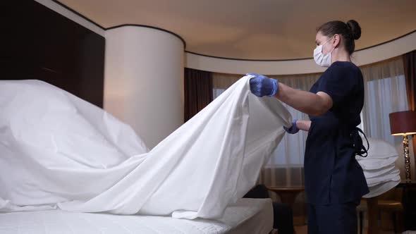 Hotel Employee Making Bed for New Guests