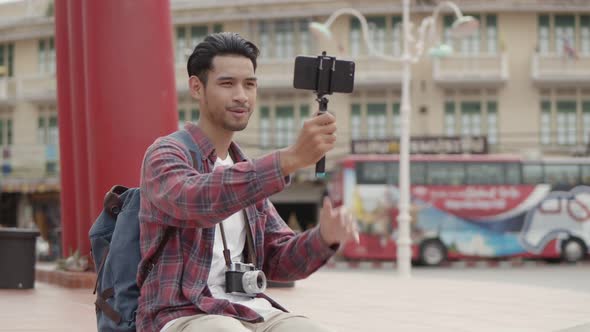 Asian man blogger recording video on mobile happy enjoying leisure lifestyle travel.