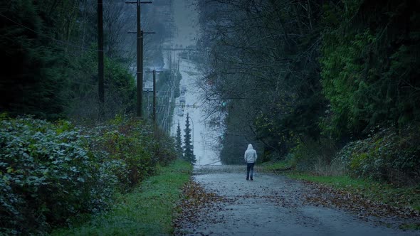 Man Walking Down Hill In The Evening