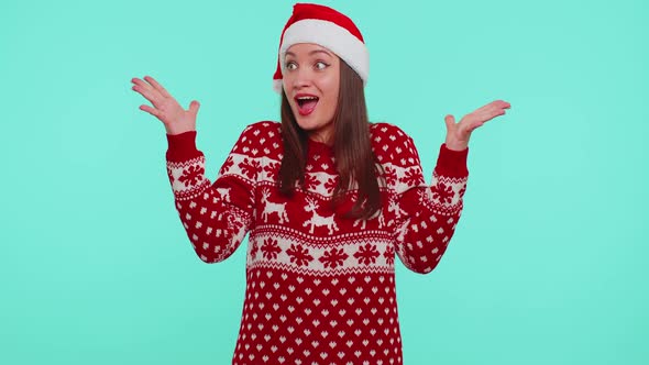 Teen Adult Girl in Christmas Hat Raising Hands in Surprise Shocked By Sudden Victory Wow Emotion