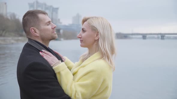 Young Caucasian Couple Dancing Slow Dance on Riverbank and Looking at Each Other with Love. Happy