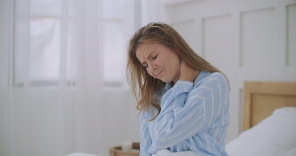 Young Woman Lying in Bed in Morning Feels Pain in Neck After Night Sleep, Awaken Having Painful