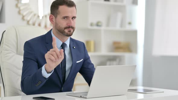 Professional Businessman with Laptop Saying No with Finger 