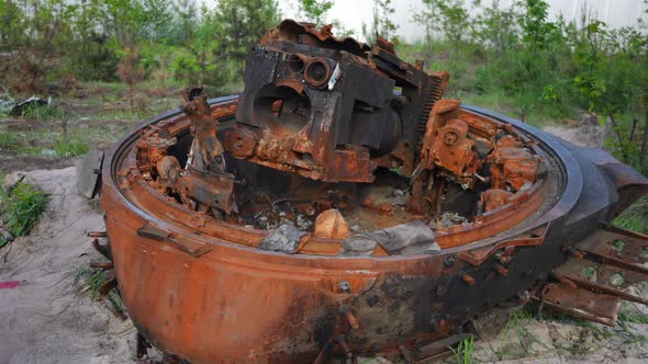 Closeup Burnt Down Hatch of Tank Lying on the Ground in Ukraine Outdoors