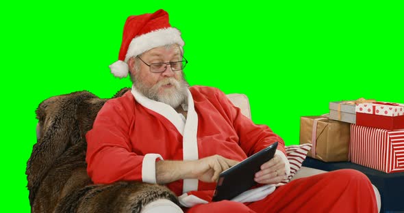 Santa claus using digital tablet 4k