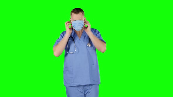 Doctor Puts a Medical Bandage on Face. Green Screen