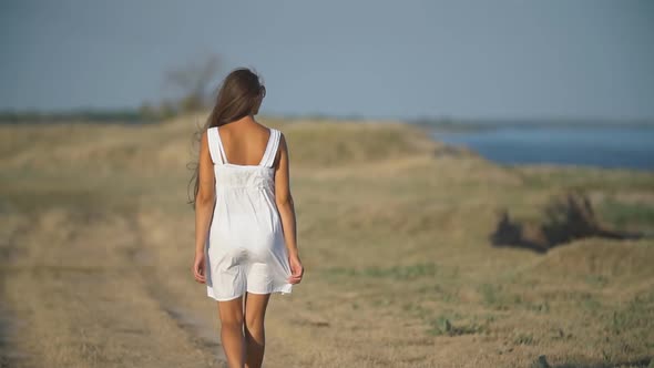 Girl in a White Dress in Nature