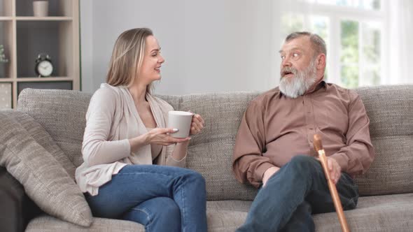 Happy Granddaughter Daughter and Grandfather Father Talking Smiling Enjoy Friendship on Couch