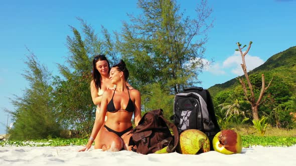 Women happy and smiling on exotic seashore beach holiday by blue sea with white sandy background of 