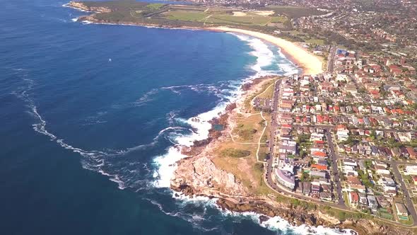 Amazing aerial shot of Sydney beach with the beautiful waves and beach front houses, Sydney, Austral