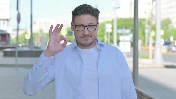 Man Showing Ok Sign with Finger Outdoor