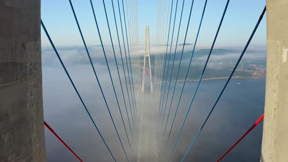 Drone Flight Over the Support of the Bridge Built Across the Sea Strait at Dawn