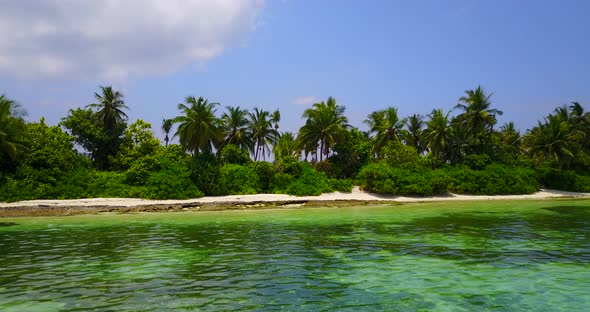 Wide overhead travel shot of a sandy white paradise beach and blue ocean background