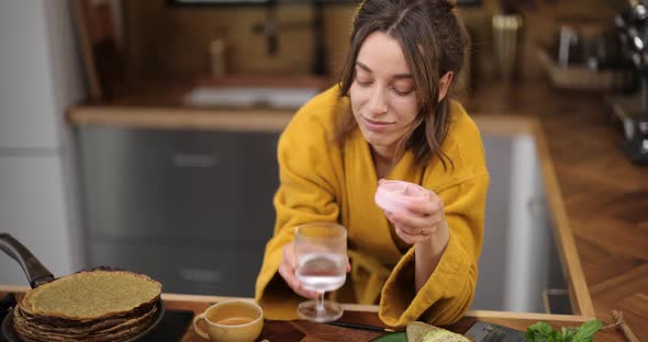 Woman Takes Pills in the Morning