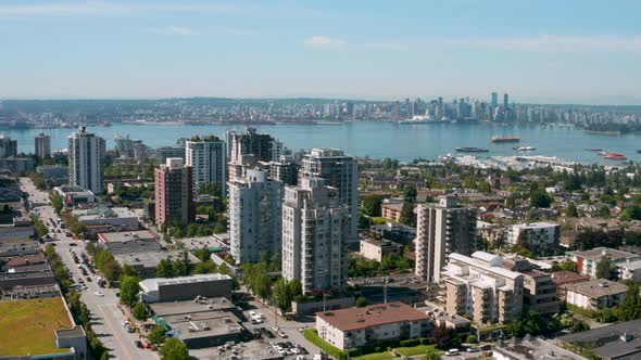 Descending aerial view of the harbour and downtown skyline from North Vancouver.