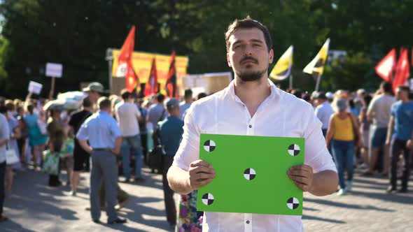 Man at a Meeting with a Banner in His Hands. Place for Your Text on Transponder