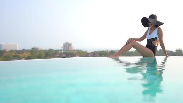 Young asian woman enjoy around outdoor swimming pool for leisure