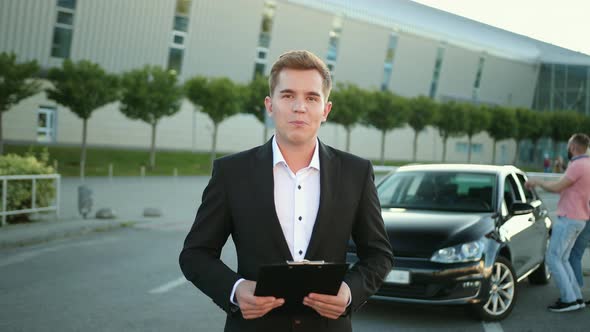 Sales Salesman Consultant with Folder in His Hand in Suit Sells Car