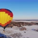 Aerial Shot of the People Fly on a Big Bright Balloon Over the Winter Forest - VideoHive Item for Sale