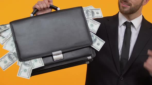 Man Pointing at Money Sticking Out From His Case, Additional Income, Capital