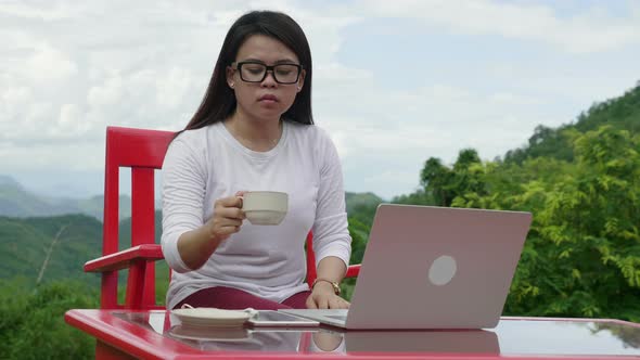 Woman Working With A Laptop And Drinking Cafe