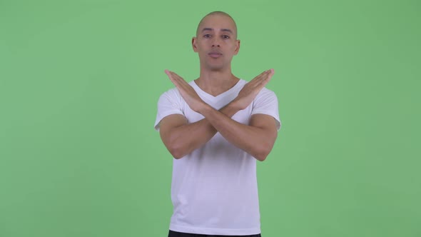 Serious Bald Man Showing Stop Gesture