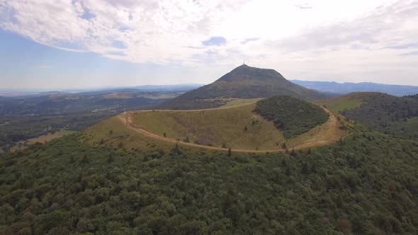 Aerial travel drone view of the Puy de Dome, lava dome volcano in France.