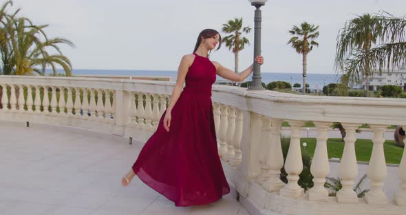 Young beautiful girl in burgundy evening dress