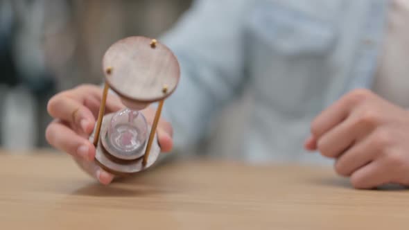 Male Hands Turning Hourglass Close Up