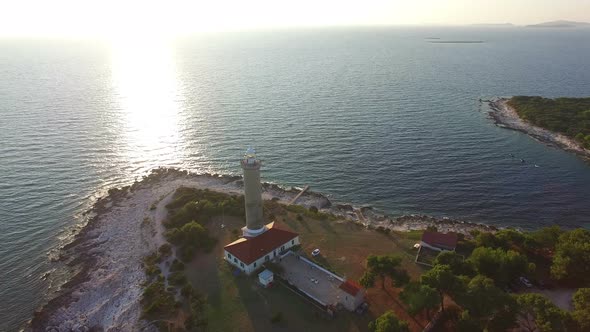 Flying over lighthouse, Croatia at sunset