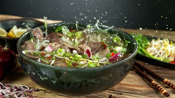 Super Slow Motion Shot of Sliced Beef Falling Into Pho Soup at 1000 Fps