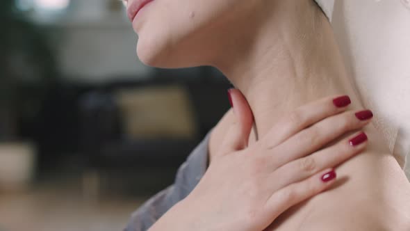 Young Woman Applying Body Lotion On Neck