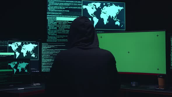 Hacker Hacking With Isolated Mock-Up Green Screen And Code On Multiple Computer Screens