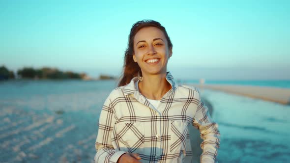 Outdoors Portrait of Happy Attractive Mixed Race Woman Enjoying Walk on Wild Sea Sand Beach at