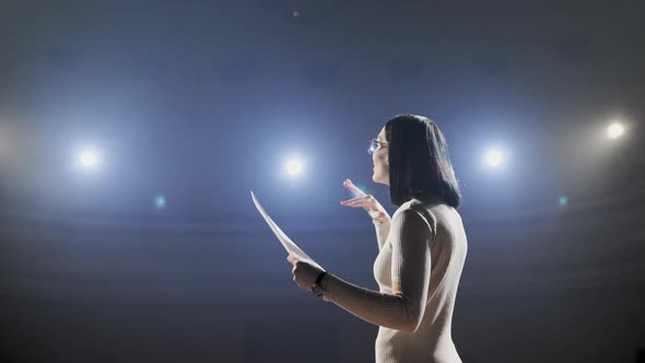 The Female Financial Coach Emotional Gesturing Talks From the Stage with Spectators at Forum