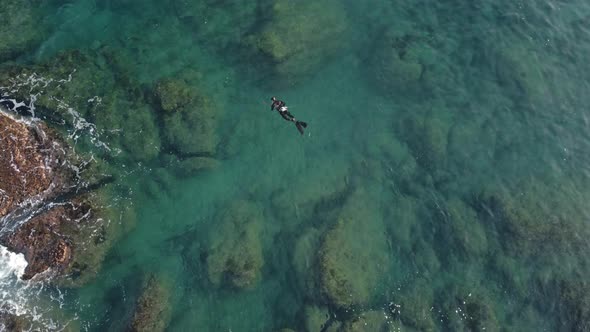 Aerial Drone View of Modern Scuba Diver or Fish Hunter with Spear Gun