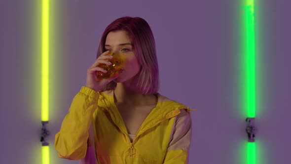 Portrait of Young Stylish Woman Drinks Water From Glass Then Spits It Out with Wow Surprised and