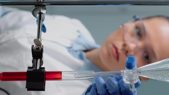 Vertical Video Close Up of Scientist Using Laboratory Glassware on Desk