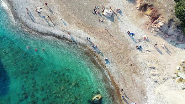 Overhead view of sunny sandy beach near Petra tou Romiou (Petra tou Romiou)