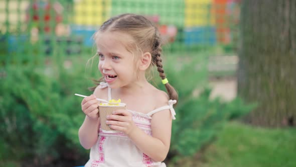 Little Girl Eat Corn Paper Glass Sitting Bench Summer Park