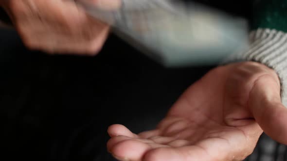 Close-up of 100 dollars banknote in the hands of a man. Cash money man hits his palm