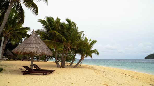 A peaceful, relaxing beach in Fiji, overlooking the waves - wide shot