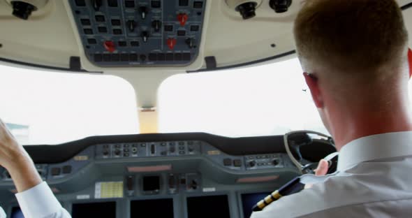 Two male pilots ready to take off private jet 4k