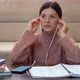 A woman in headphones learns to speak a foreign language, online lesson - VideoHive Item for Sale