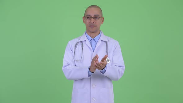 Happy Bald Multi Ethnic Man Doctor Clapping Hands